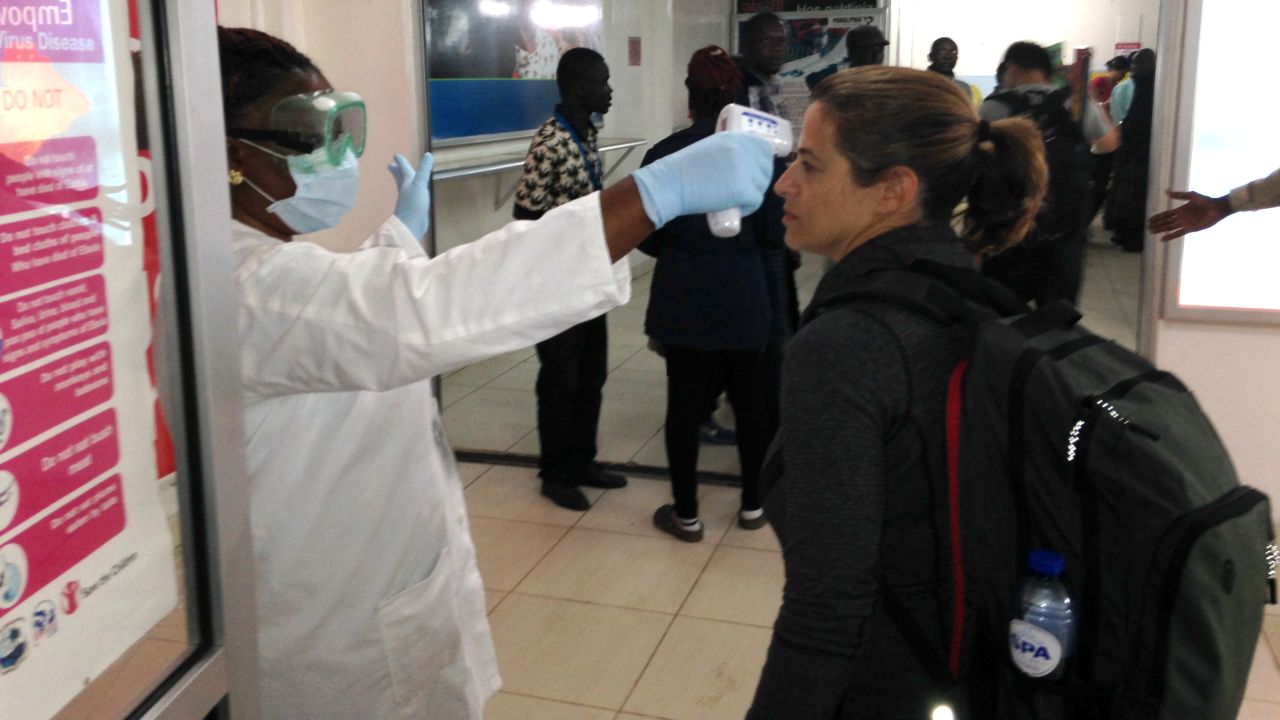 After getting off the plane, Elizabeth Cohen has her temperature taken, since a fever is one symptom of Ebola. Her temperature was normal.
