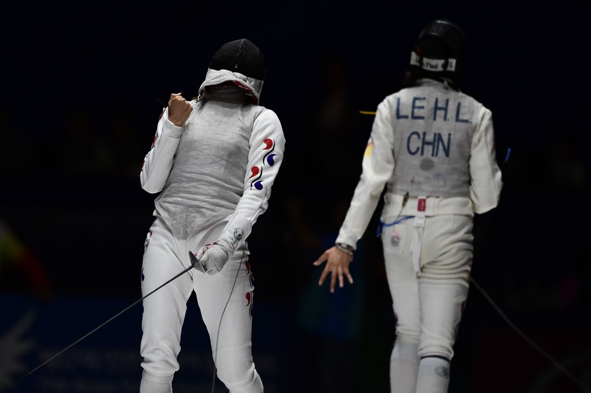 Jeon Hee-Sook of South Korea wins a point against Le Huilin of China during the women's foil fencing individual final, September 21. Jeon later won the gold medal, her first individual Asiad title.