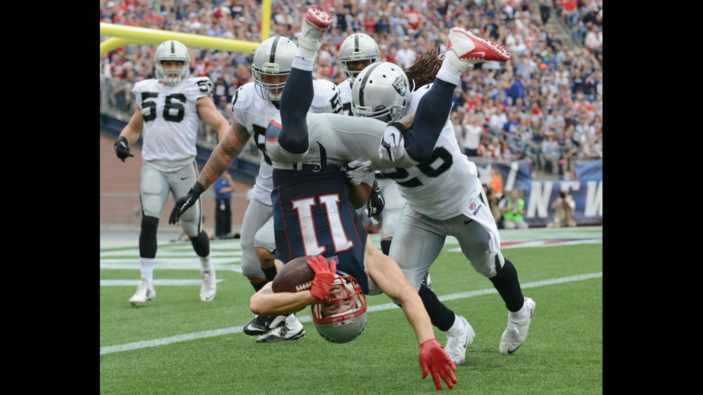 New England Patriots wide receiver Julian Edelman is tackled by Oakland Raiders during the Patriots' 16-9 win Sunday, September 21, in Foxborough, Massachusetts. Edelman had 10 receptions in the game for 84 yards.