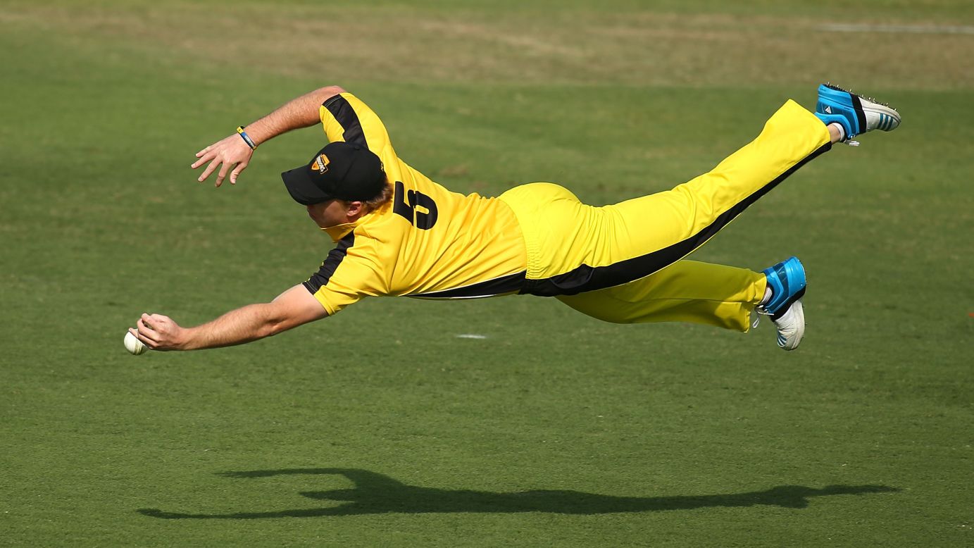 Cricket player Jaron Morgan dives for a catch Monday, September 22, as his Western Australia XI played Afghanistan in a One Day tour match in Perth, Australia. 