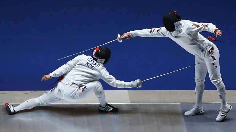South Korean fencers Jung Jin-sun, right, and Park Kyoung-doo face off in the men's epee final Saturday, September 20, at the Asian Games in Incheon, South Korea. Jung defeated his compatriot to win the gold medal.