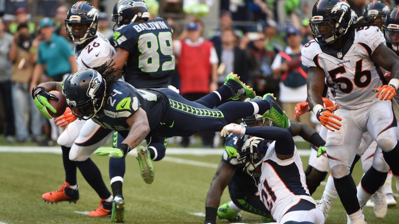 Seattle Seahawks running back Marshawn Lynch dives into the end zone to defeat the Denver Broncos in overtime Sunday, September 21, in Seattle. The Seahawks won 26-20 in what was a rematch of the most recent Super Bowl.