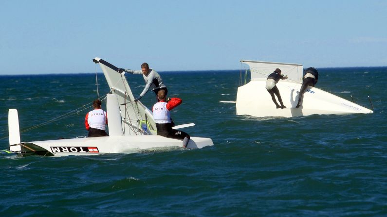 Sailors try to lift their ships after they capsized in strong winds Wednesday, September 17, at the ISAF Sailing World Championships in Santander, Spain.