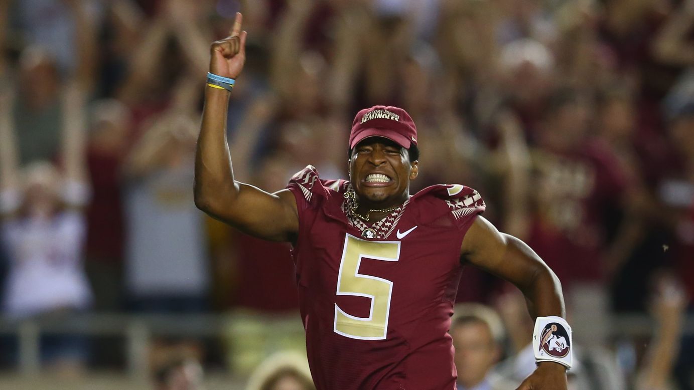 Florida State quarterback Jameis Winston runs onto the field to celebrate his team's overtime win over Clemson on Saturday, September 20, in Tallahassee, Florida. Winston, last year's Heisman Trophy winner, <a href="http://www.cnn.com/2014/09/20/us/florida-state-winston-suspension/index.html">was suspended for the game</a> because of a vulgar comment he made on campus during the week.