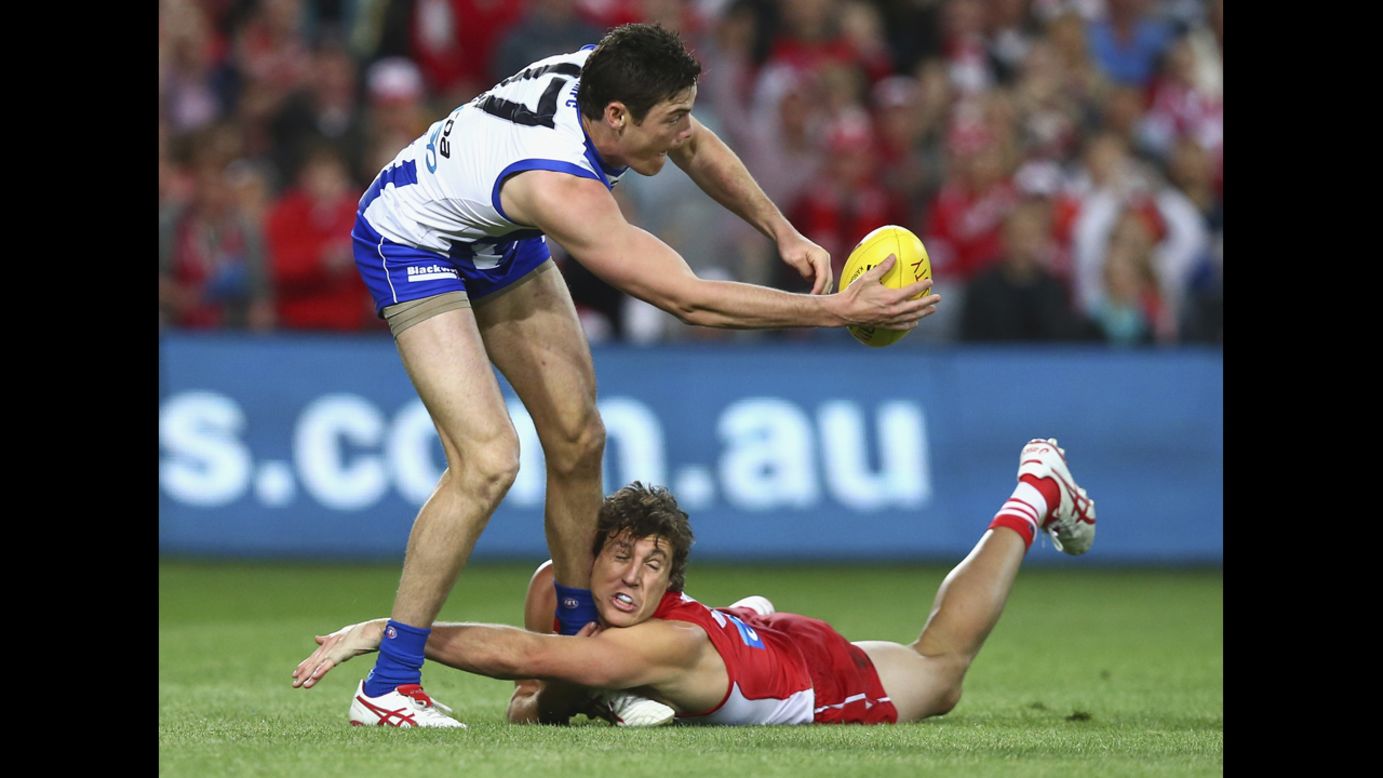 Kurt Tippett of the Sydney Swans tackles Nathan Grima of the North Melbourne Kangaroos during one of the Australian Football League's preliminary finals on Friday, September 19. Sydney won and advanced to the grand final against Hawthorn.
