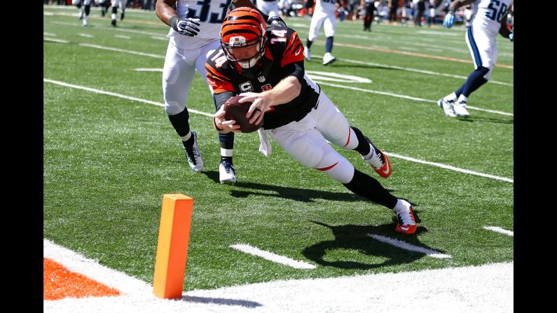 Cincinnati Bengals quarterback Andy Dalton reaches for the pylon during his team's 33-7 victory over the Tennessee Titans on Sunday, September 21. The Bengals are one of three NFL teams still undefeated this season. The Philadelphia Eagles and the Arizona Cardinals are also 3-0.