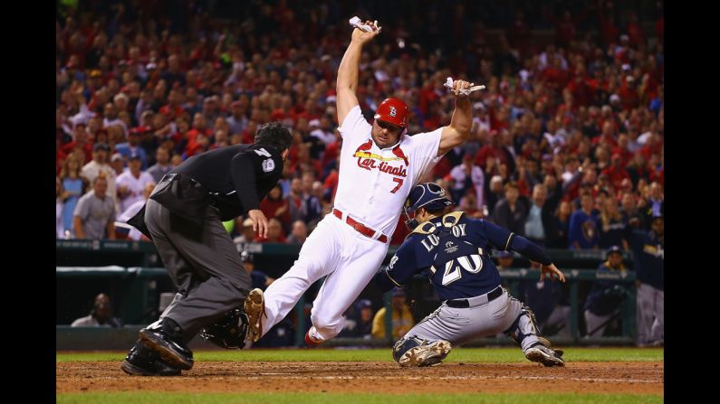 Matt Holliday of the St. Louis Cardinals scores a run against the Milwaukee Brewers during a game played Wednesday, September 17, in St. Louis.