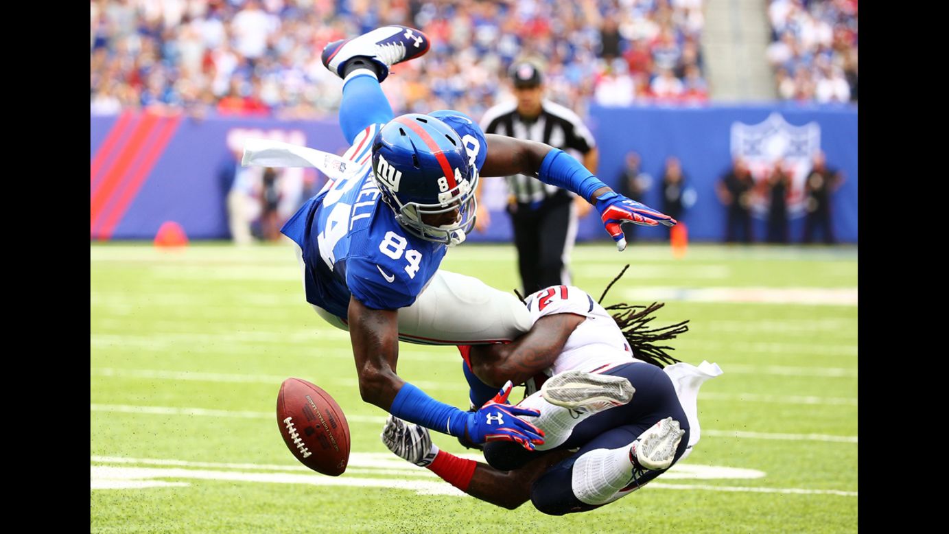 Kendrick Lewis of the Houston Texans, right, hits New York Giants tight end Larry Donnell and forces a fumble during an NFL game Sunday, September 21, in East Rutherford, New Jersey. <a href="http://www.cnn.com/2014/09/16/worldsport/gallery/what-a-shot-0915/index.html">See 34 amazing sports photos from last week</a>