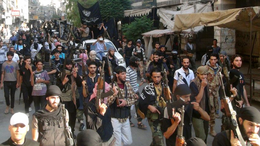Islamic fighters from the al-Qaida group in the Levant, Al-Nusra Front, parade at the Yarmuk Palestinian refugee camp, south of Damascus, to denounce Israels military offensive on the Gaza Strip, on July 28, 2014. Israeli shells struck a UN school in Gaza early today, killing 16, as ground troops made a signficant push into the territory despite Palestinian efforts to broker a 24-hour truce. AFP PHOTO/RAMI AL-SAYED        (Photo credit should read RAMI AL-SAYED/AFP/Getty Images)