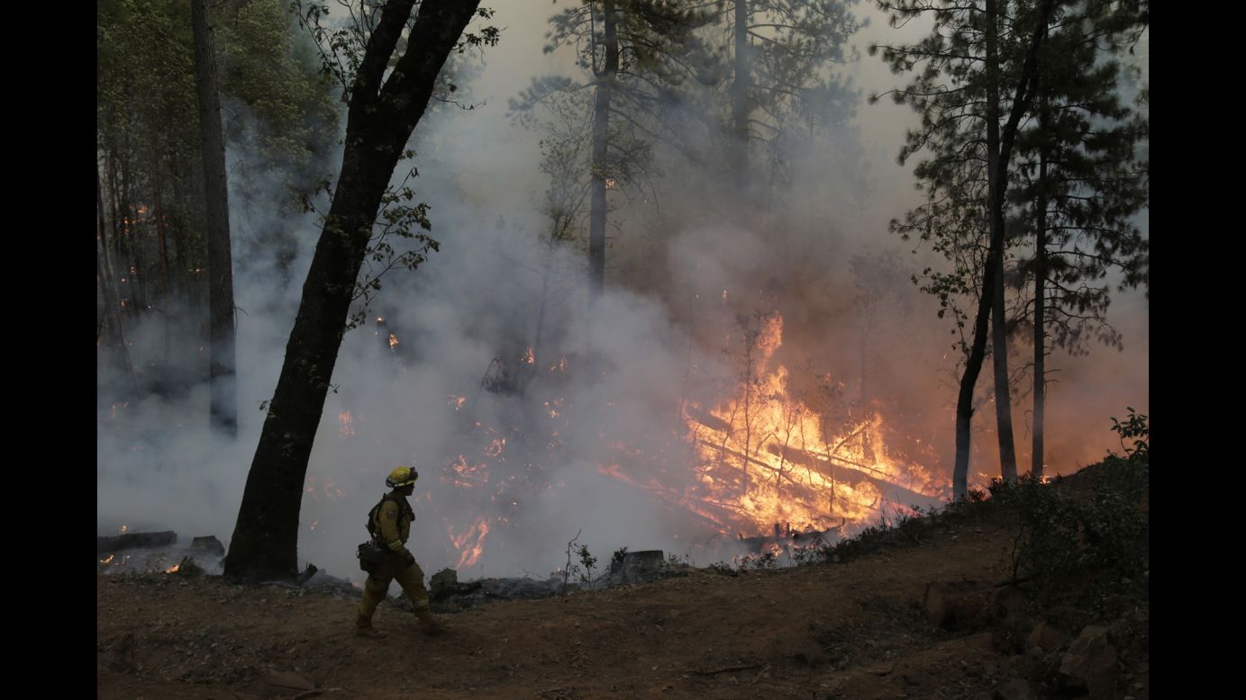 A firefighter walks along the containment line during a controlled burn near Placerville on September 22.