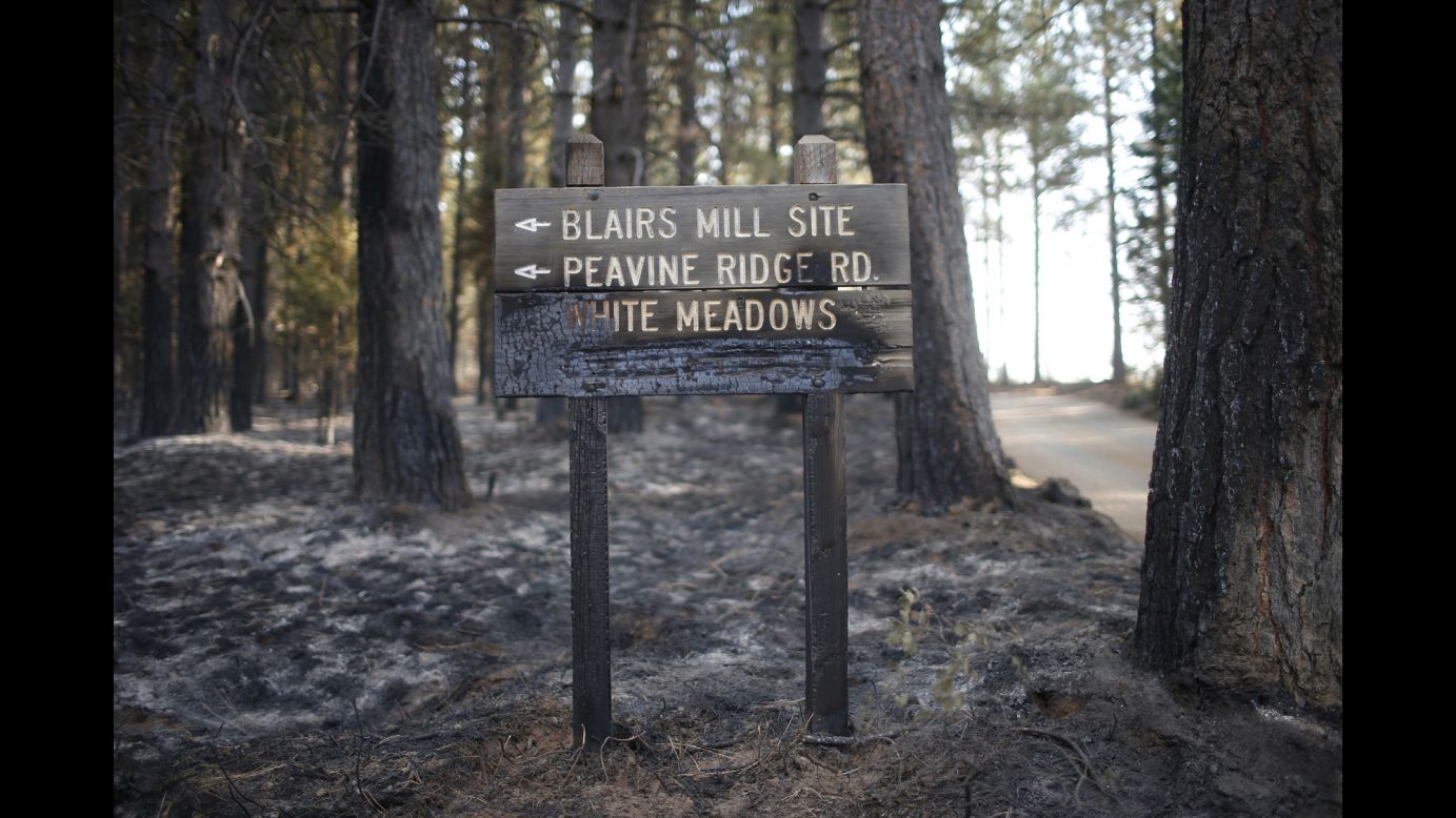 A sign stands half-burned by the King Fire in White Meadows, California, on Saturday, September 20.