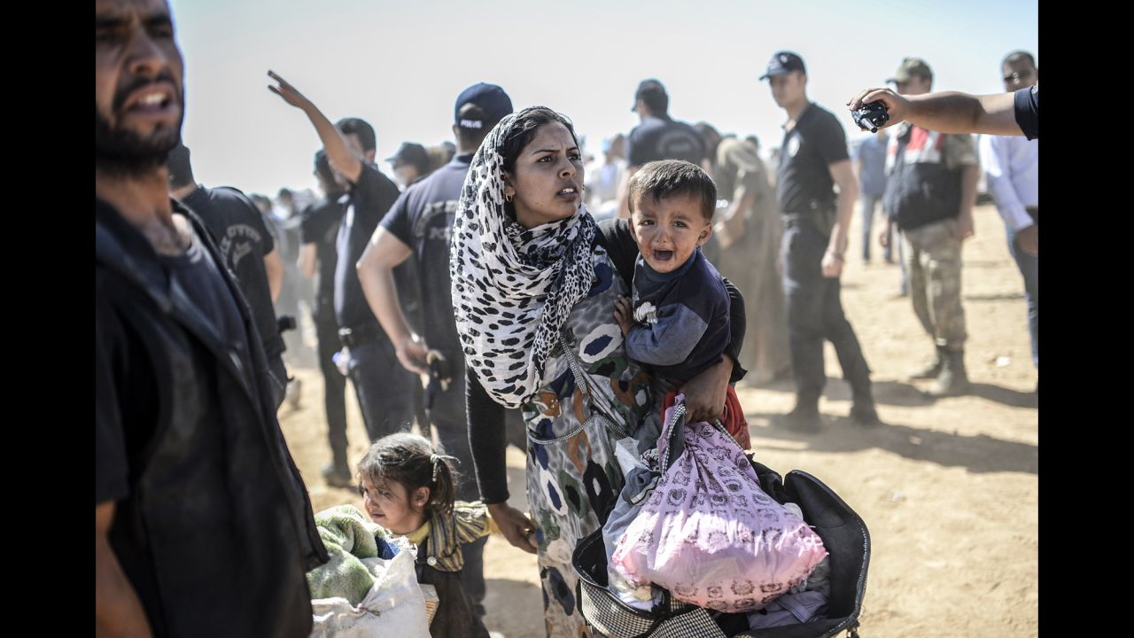 A Kurdish woman crosses into Suruc on Tuesday, September 23. 