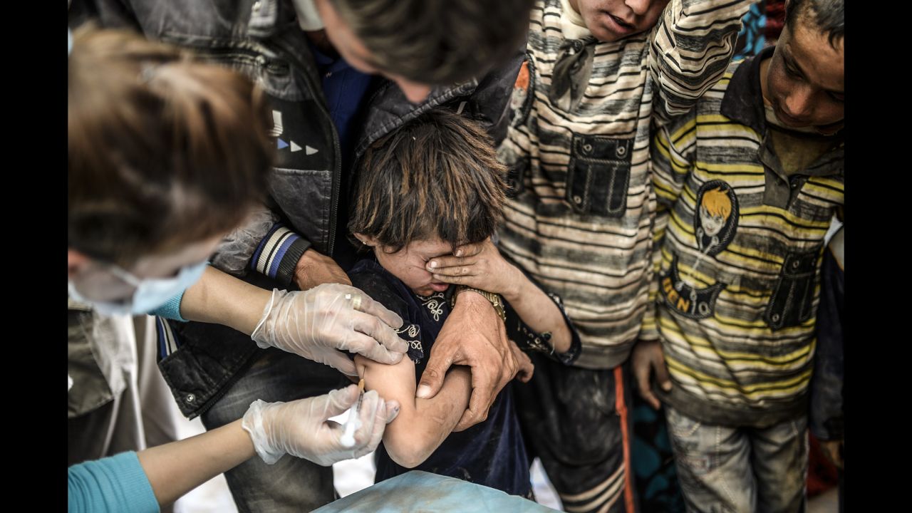 A Syrian Kurdish boy is vaccinated as he arrives in Suruc on September 23. The United Nations estimates that more than 2.5 million Syrians have fled their country since an uprising in March 2011 spiraled into civil war.