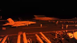 In this photo released by the U.S. Navy, A-18E Super Hornet, attached to Strike Fighter Squadron (VFA) 31, and an F/A-18F Super Hornet, attached to Strike Fighter Squadron (VFA) 213, prepare to launch from the flight deck of the aircraft carrier USS George H.W. Bush (CVN 77) to conduct strike missions against Islamic State group targets, in the Arabian Gulf, Tuesday, Sept. 23, 2014.