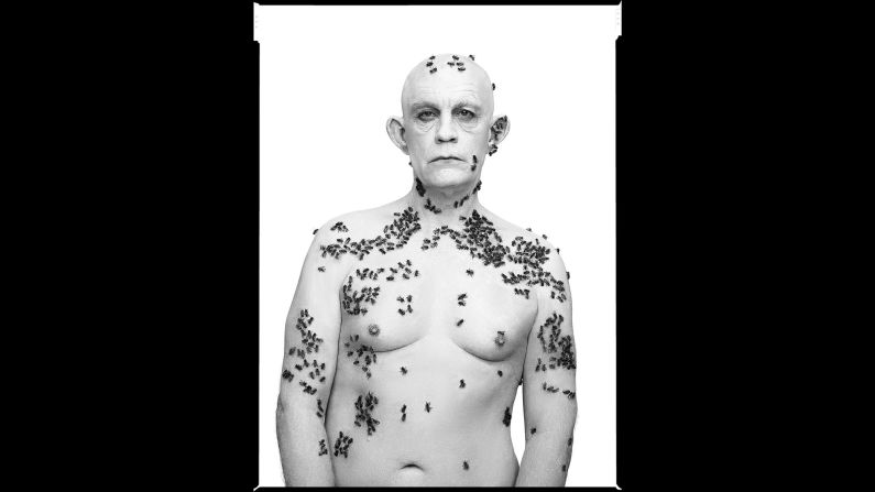 Malkovich, covered in bees, re-creates the "Ronald Fischer, Beekeeper" photo taken by Richard Avedon in 1981.