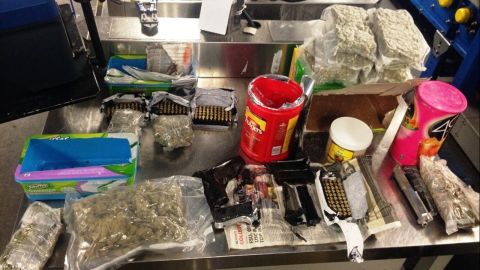 The agency says a woman attempted to smuggle a gun and marijuana through Kennedy International Airport security inside baby wipes, coffee, floor dusting sheets and other household products. 