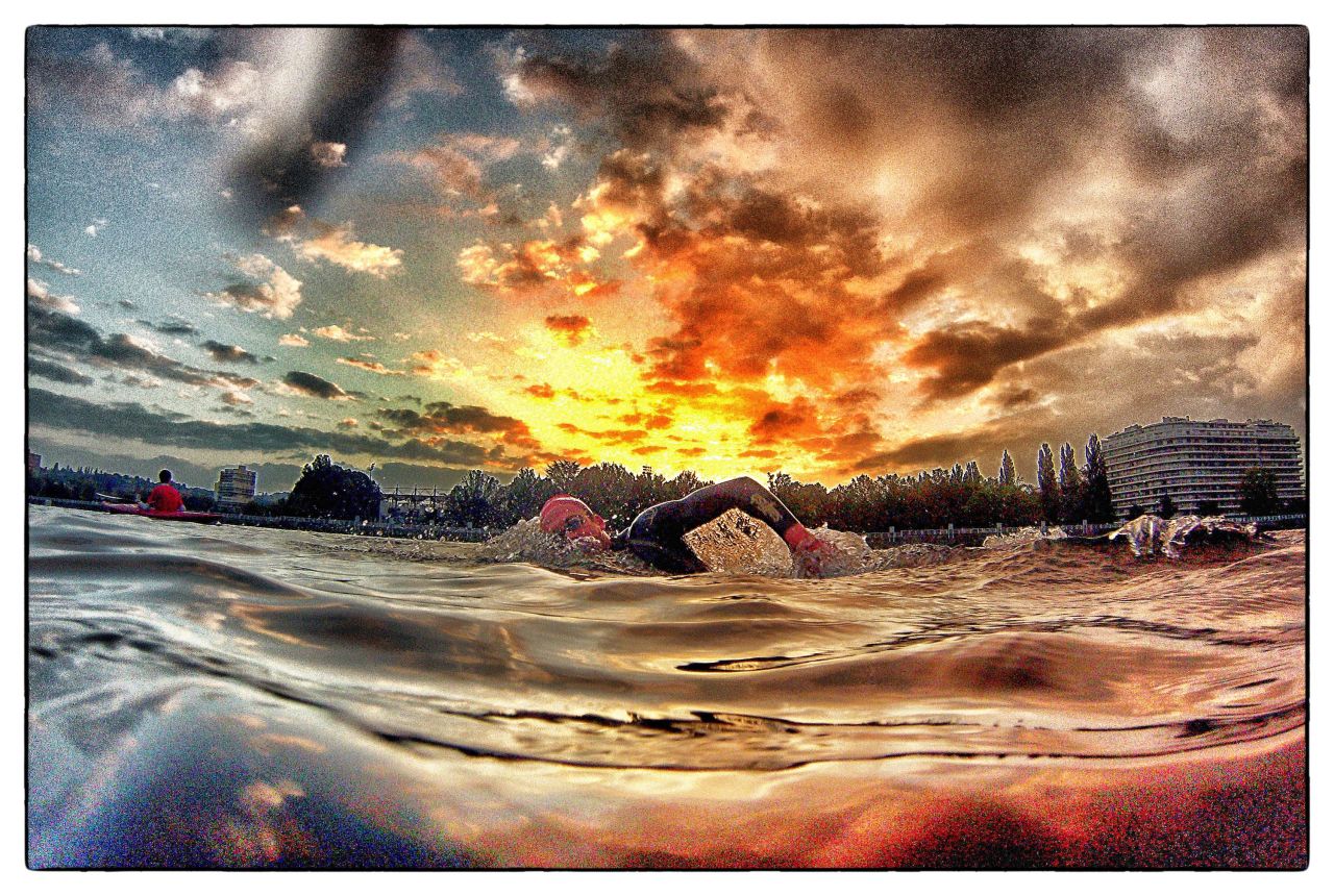 This photograph by Crowhurst almost has a volcanic feel about it, setting the swimmer against the backdrop of the fiery red sun setting in the distance.