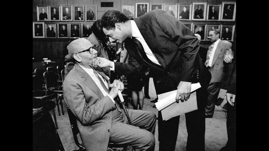 Holder talks with his father, Eric Holder Sr., after being sworn in as the U.S. attorney for the District of Columbia in 1993. 