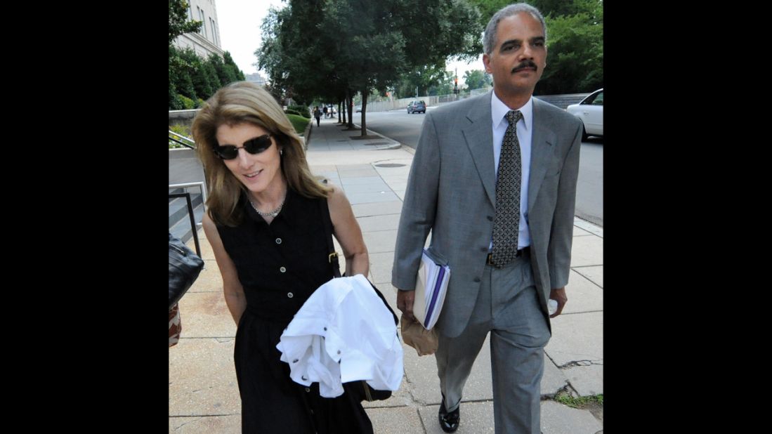 Holder walks with Caroline Kennedy, daughter of former President John F. Kennedy, in June 2008 after they were tasked with searching for a running mate for then-Sen. Barack Obama.