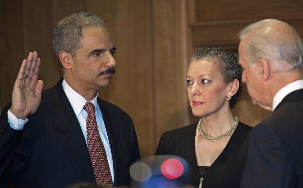 Holder is sworn in as attorney general by Vice President Joe Biden in February 2009. Holder's wife, Dr. Sharon Malone, is by his side.