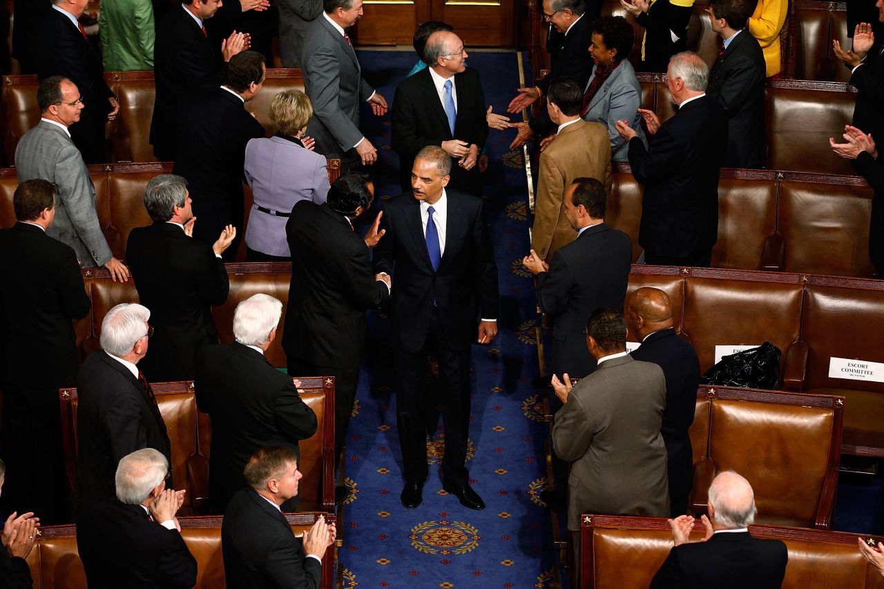 Holder is greeted by members of Congress as he arrives at the U.S. House of Representatives in May 2010.