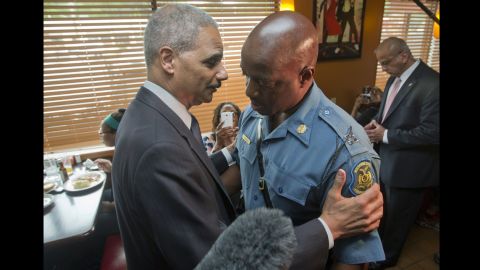 U.S. Attorney General Eric Holder talks with Capt. Ron Johnson, right, of the Missouri State Highway Patrol on August 20, 2014 in Ferguson, Missouri.