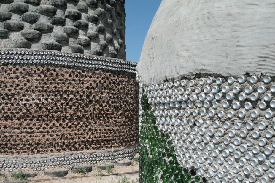 Tires, cans and bottles are mixed with concrete to make different walls for the earthships.
