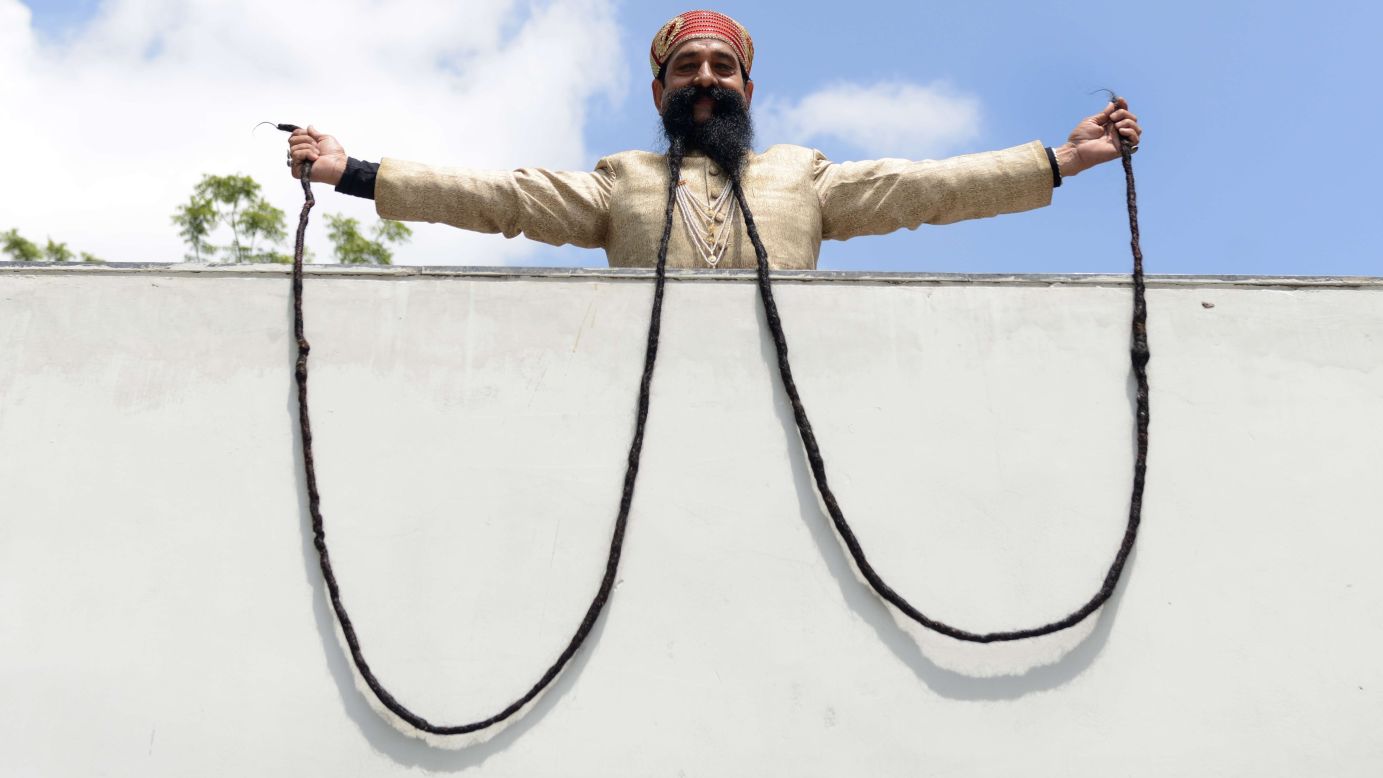 Ram Singh Chauhan shows off his 18-foot mustache Wednesday, September 24, in Ahmedabad, India. It is the world's longest mustache, according to the Guinness Book of World Records.