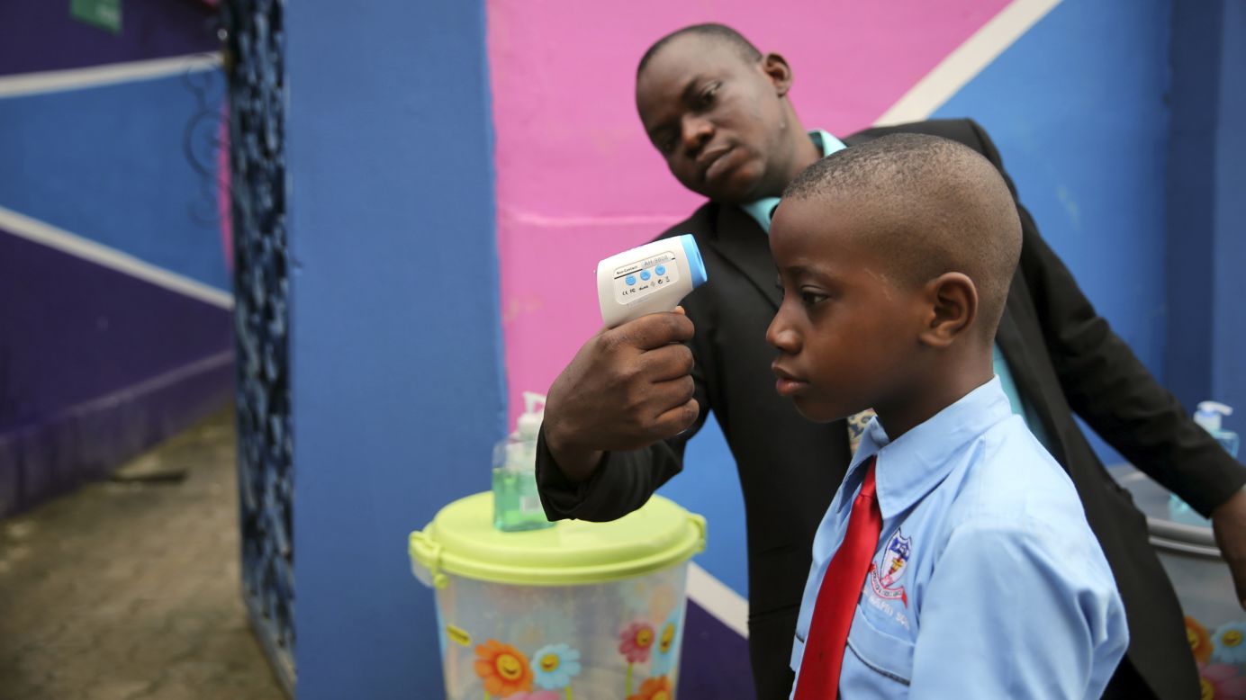 A school official takes a student's temperature with an infrared laser thermometer Monday, September 22, in Lagos, Nigeria. Health officials say <a href="http://www.cnn.com/2014/04/04/world/gallery/ebola-in-west-africa/index.html">the Ebola outbreak in West Africa</a> is the deadliest ever. As of September 21, the total number of probable, confirmed and suspected cases of Ebola was more than 6,000, with nearly 3,000 deaths, the World Health Organization said.