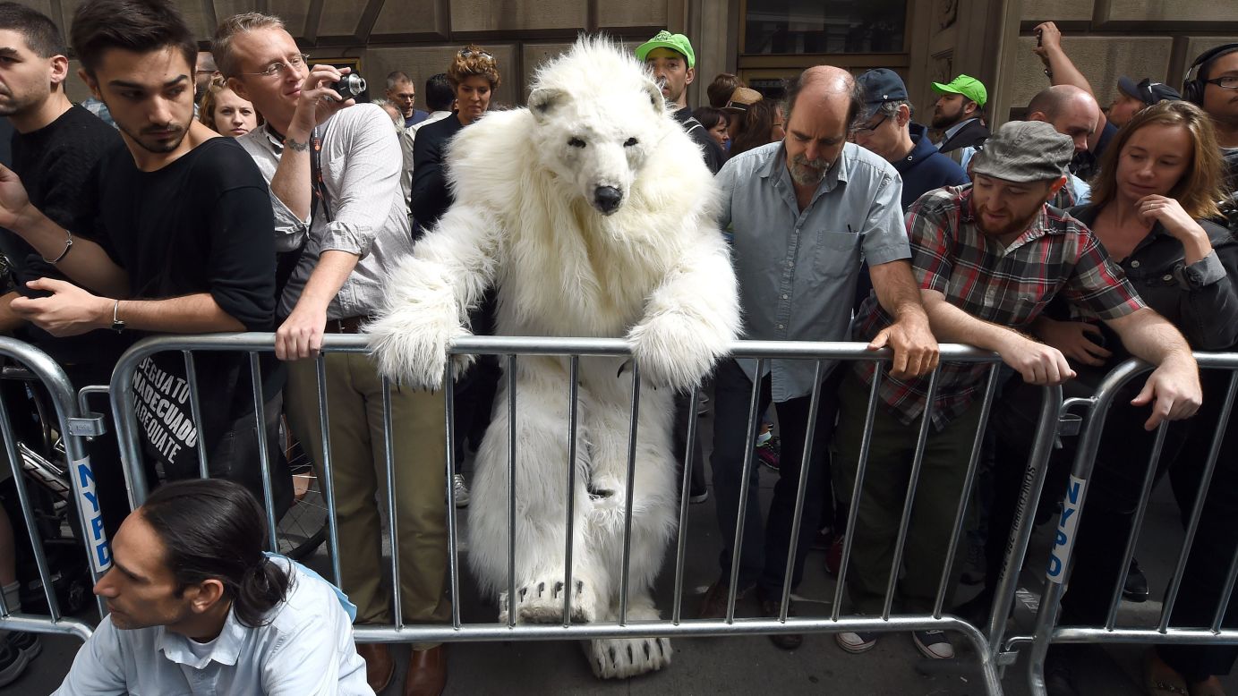 A man dressed as a polar bear climbs a barricade Monday, September 22, as protesters took part in the "Flood Wall Street" demonstrations that preceded the U.N. Climate Summit in New York.
