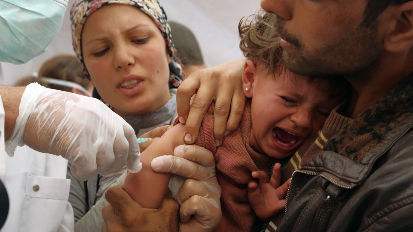 A refugee girl is vaccinated shortly after she and her parents crossed into Suruc, Turkey, on Wednesday, September 24. Because of the militant group ISIS, <a href="http://www.cnn.com/2013/03/05/world/gallery/syrian-refugees/index.html">as many as 200,000 people have fled</a> the area surrounding the Syrian city of Kobani, also known as Ayn al-Arab, the Syrian Observatory for Human Rights said Monday, September 22.