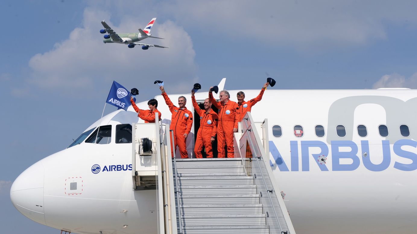 The crew of the Airbus A320neo waves to observers in Blagnac, France, after the plane's first test flight on Thursday, September 25. The A320neo is the revamped and more fuel-efficient version of Airbus' most popular single-aisle passenger jet.