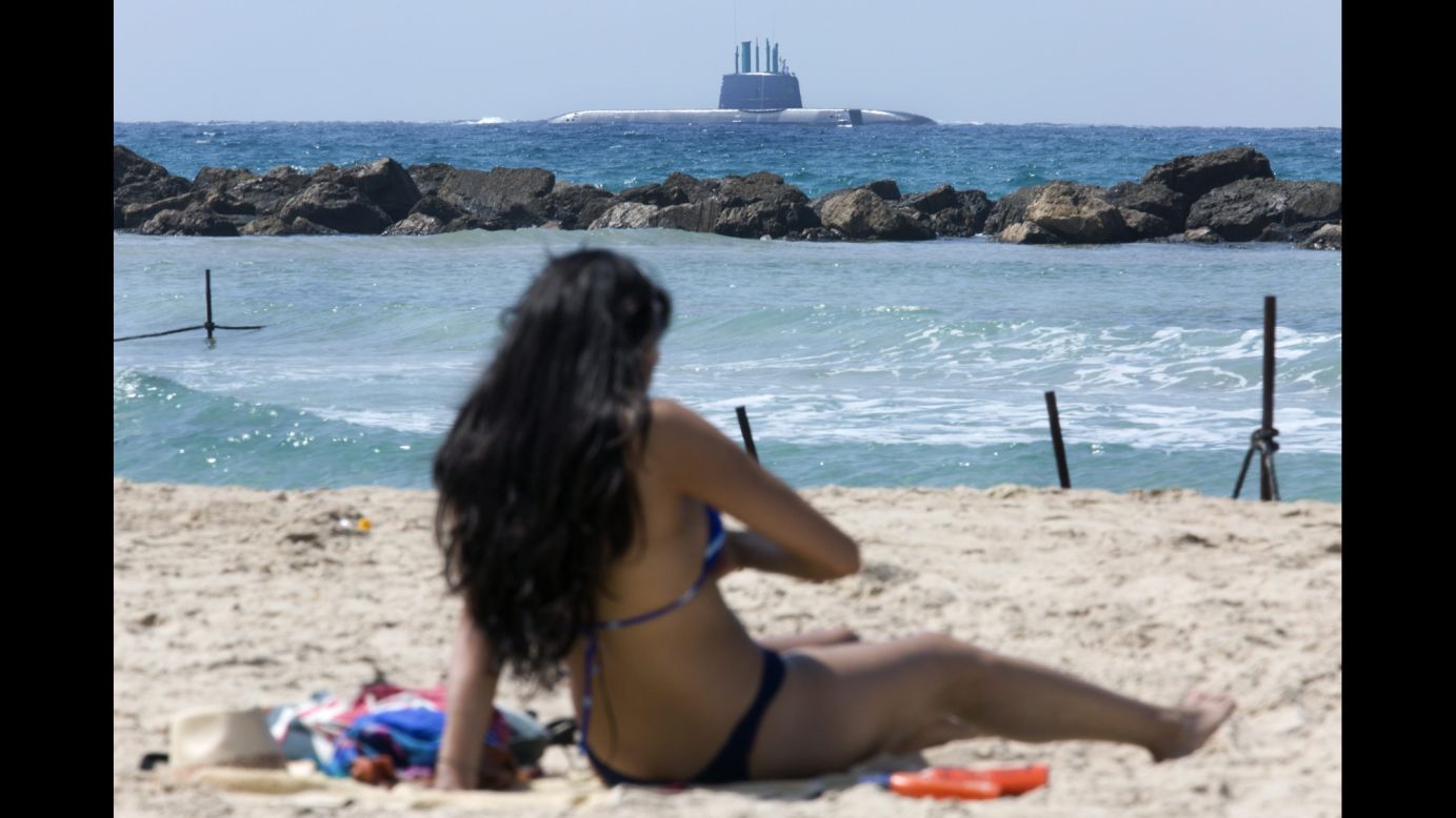 Israel's new submarine, the INS Tanin, is seen from a beach in Haifa, Israel, on Tuesday, September 23. The sub was making its final approach into Haifa's port after being built in Germany. 