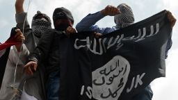 Caption:Kashmiri demonstrators hold up a flag of the Islamic State of Iraq and the Levant (ISIL) during a demonstration against Israeli military operations in Gaza, in downtown Srinagar on July 18, 2014. The death toll in Gaza hit 265 as Israel pressed a ground offensive on the 11th day of an assault aimed at stamping out rocket fire, medics said. AFP PHOTO/Tauseef MUSTAFA (Photo credit should read TAUSEEF MUSTAFA/AFP/Getty Images)
