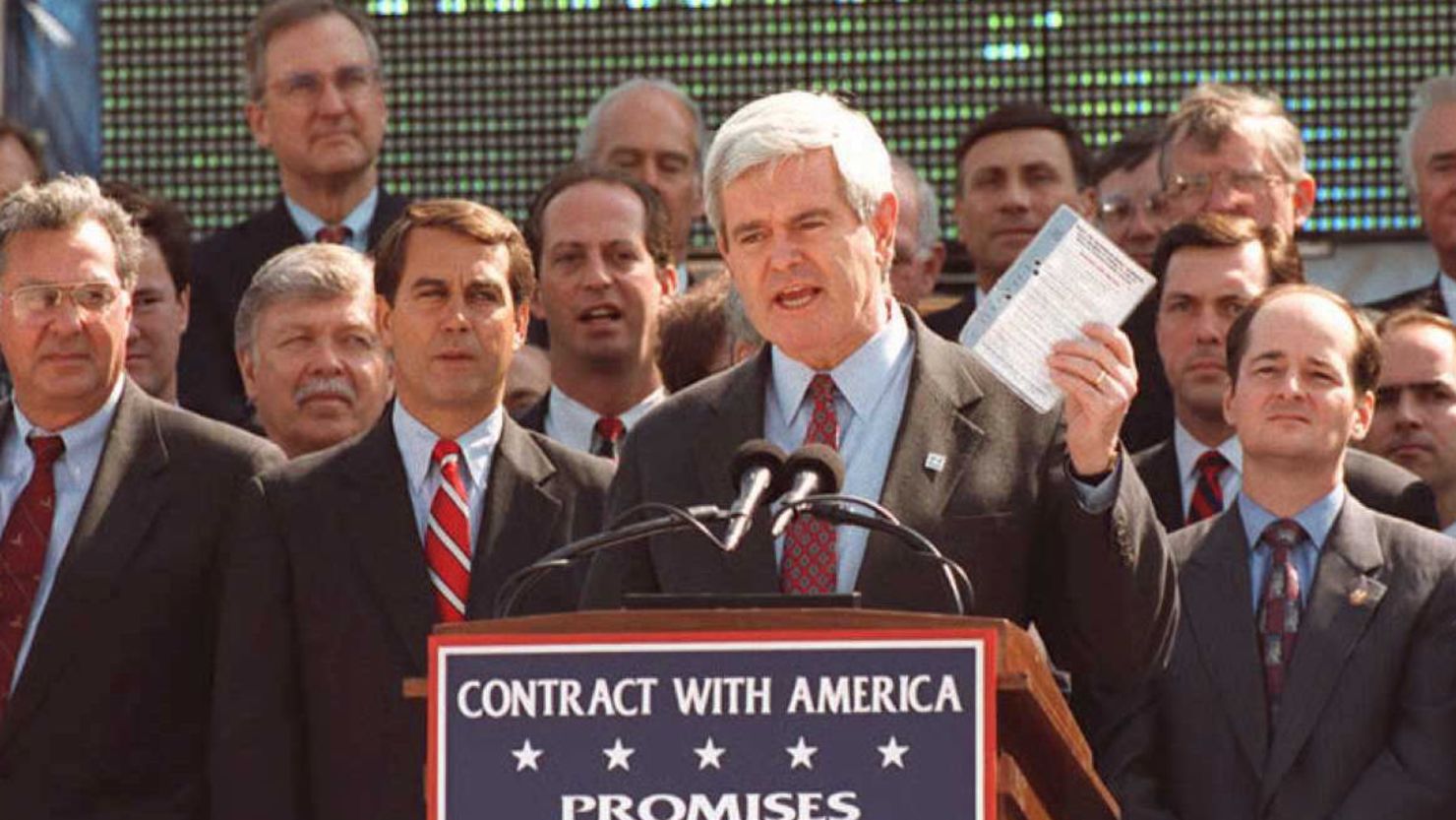 Newt Gingrich, speaker of the house in 1995, holds up a copy of the Contract With America on the steps of the U.S. Capitol. 