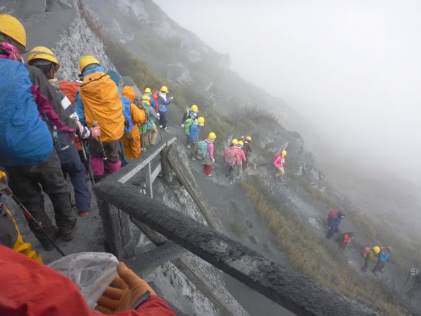 Climbers flee the mountain as the eruption coats the area in a layer of ash.