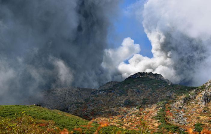 Smoke and ash rise from the summit crater of Mount Ontake.