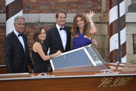 Model Cindy Crawford, right, boards a taxi boat with her husband, Rande Gerber, and other guests. 