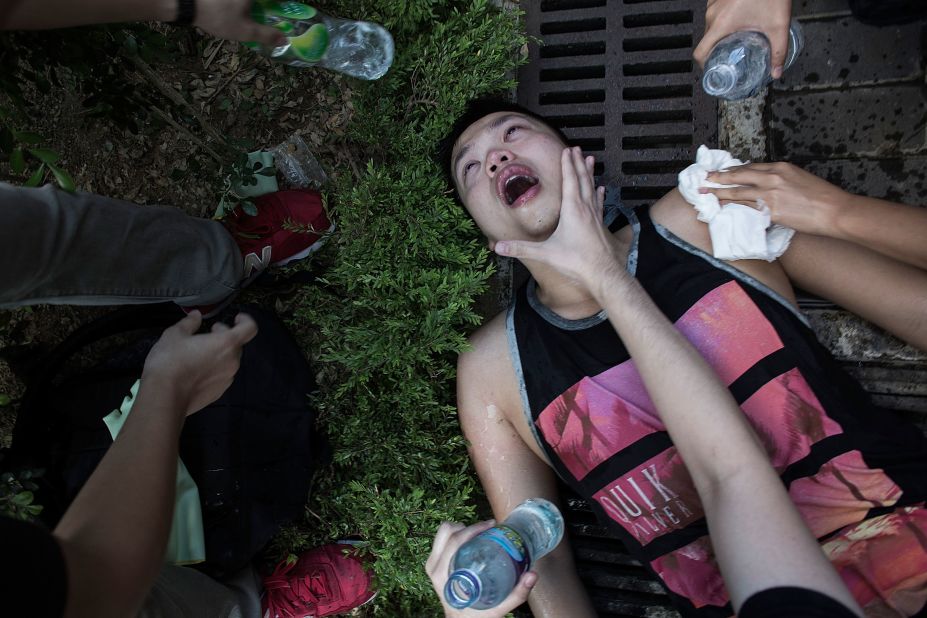 An injured protester is tended to after clashing with riot police outside Hong Kong government complex on Saturday, September 27.