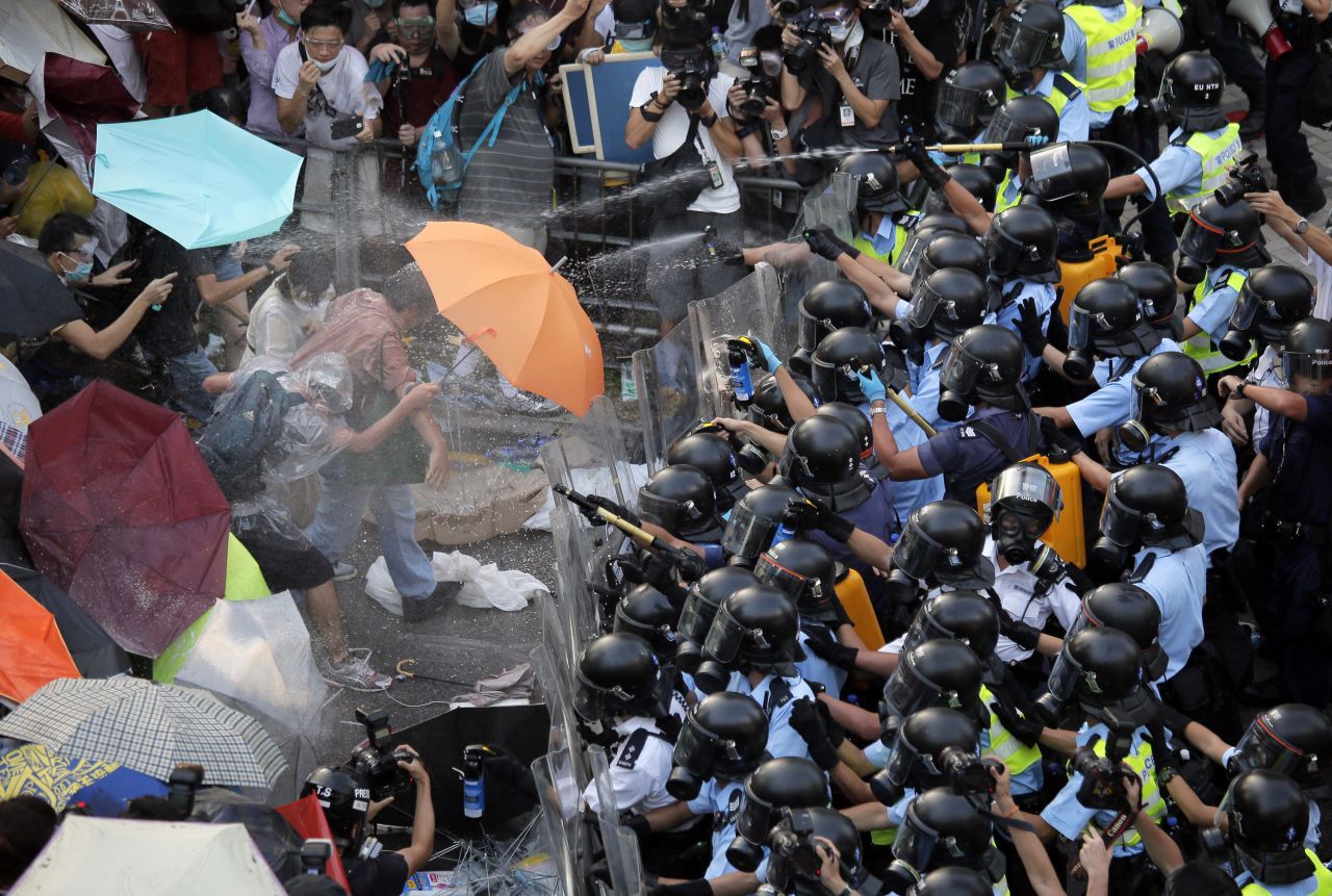 Police and protesters clash during a tense standoff with thousands of student demonstrators, recently joined by the like-minded Occupy Central movement, on September 28.