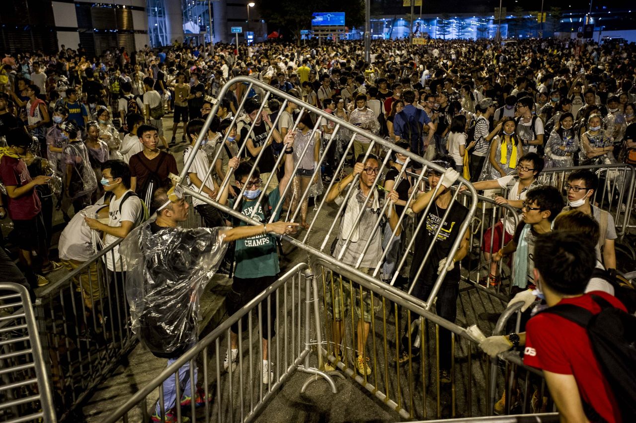 Protesters tie up barricades on September 28 during a demonstration outside the headquarters of the Legislative Council in Hong Kong. 