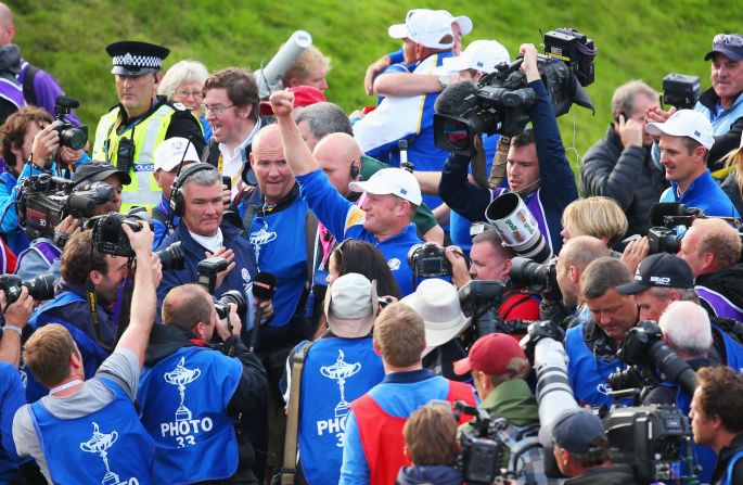 Jamie Donaldson is surrounded by fans and the media after clinching the Ryder Cup for Europe with a win over Keegan Bradley. 