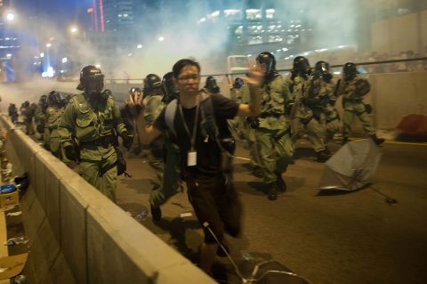 Demonstrators disperse as tear gas is fired during a protest on September 28. There is an "optimal amount of police officers dispersed" around the scene, a Hong Kong police representative said.