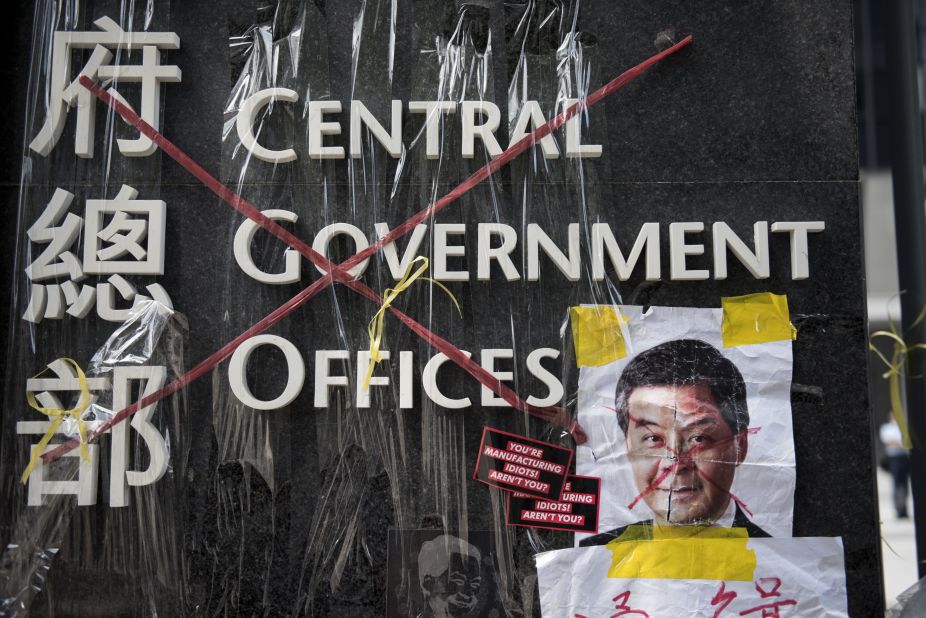A sign for the Hong Kong central government offices has been crossed out with red tape by democracy activists on September 28.