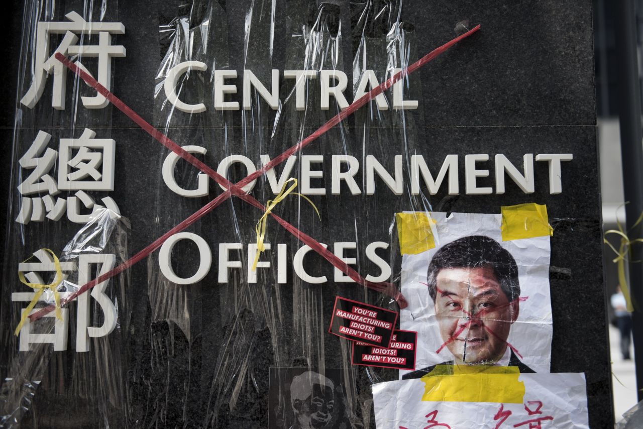 A sign for the Hong Kong central government offices has been crossed out with red tape by democracy activists on September 28. 