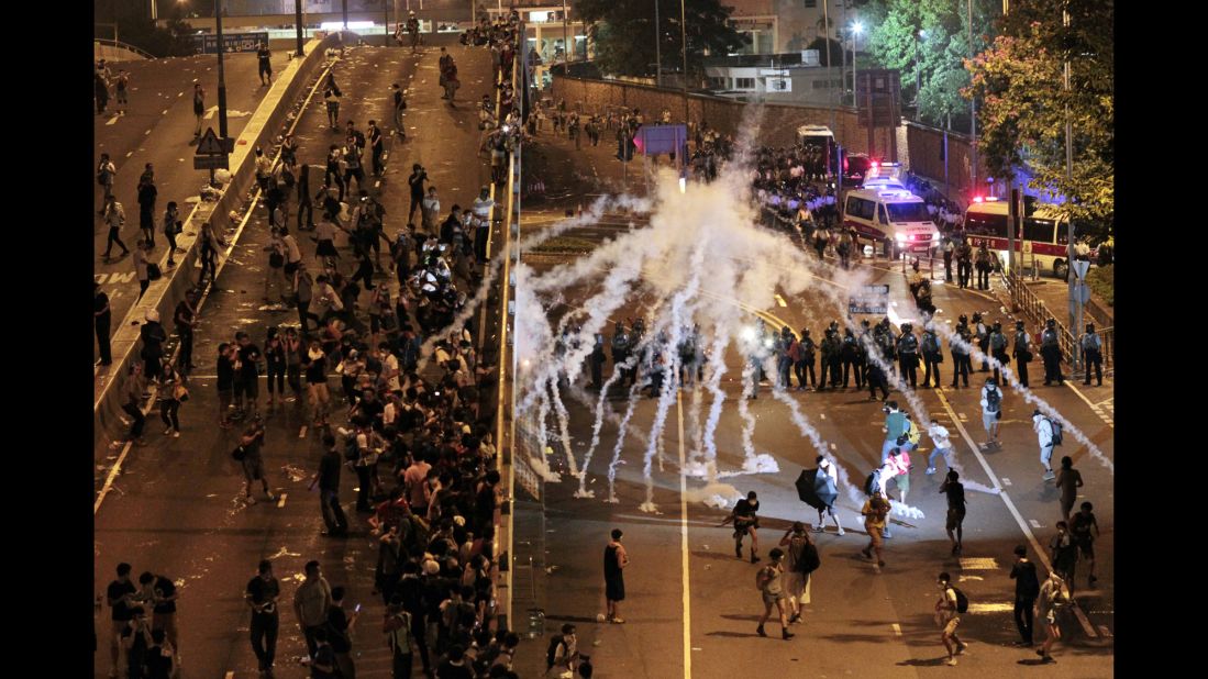 Riot police fire tear gas on student protesters occupying streets around government buildings in Hong Kong on September 29.