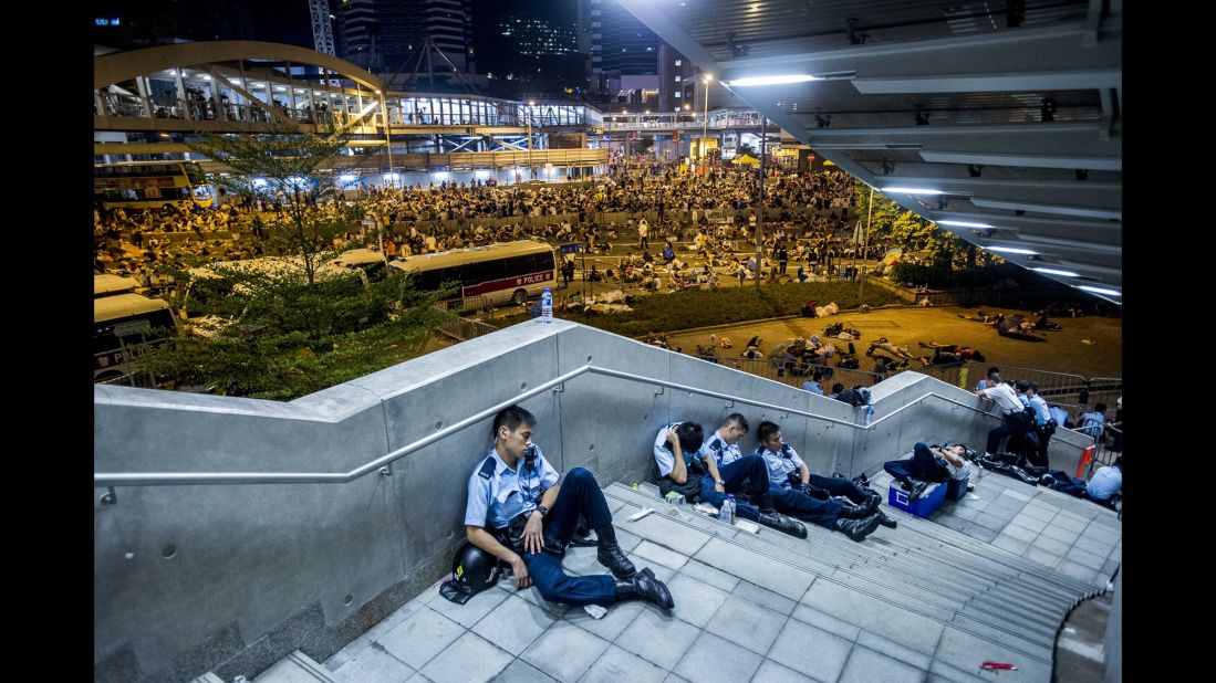 Police officers rest after protests on September 29. 