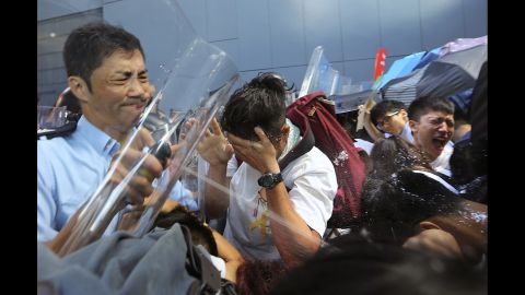 Riot police use pepper spray on pro-democracy activists who forced their way into the Hong Kong government headquarters during a demonstration on September 27.