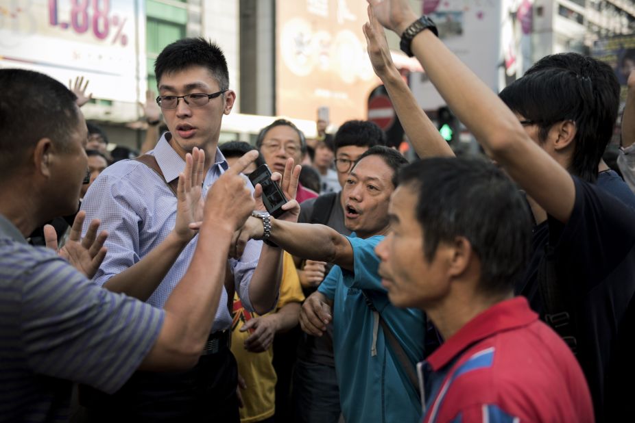 Pro-democracy protesters argue with a man, left, who opposes the occupation of Nathan Road in Hong Kong on September 29. 