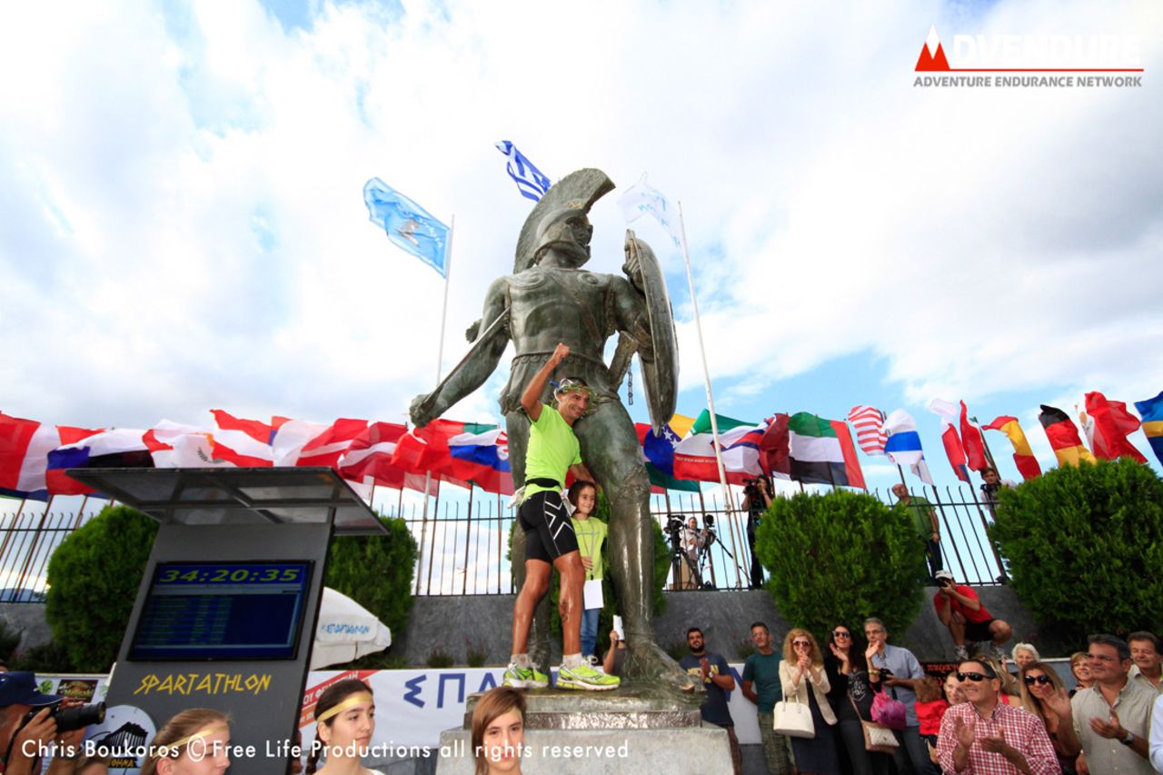 A competitor celebrates by mounting the statue. The event attracts runners from all over the world including 55 from Japan, 40 German entrants and 11 from the U.S. this year.
